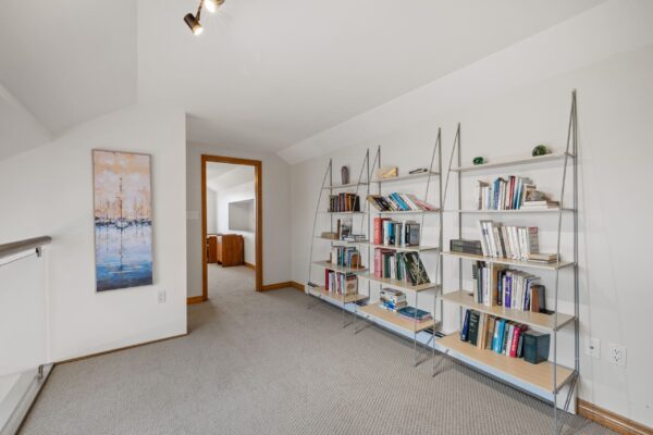 Loft library and lounge area overlooking kitchen. St. Andrews Point Beach House. Main Residence.